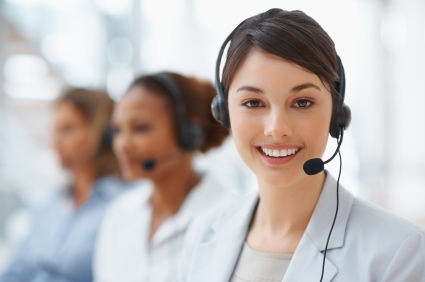 iStock_000012107877XSmall Closeup of a cute business woman with headset at workplace
